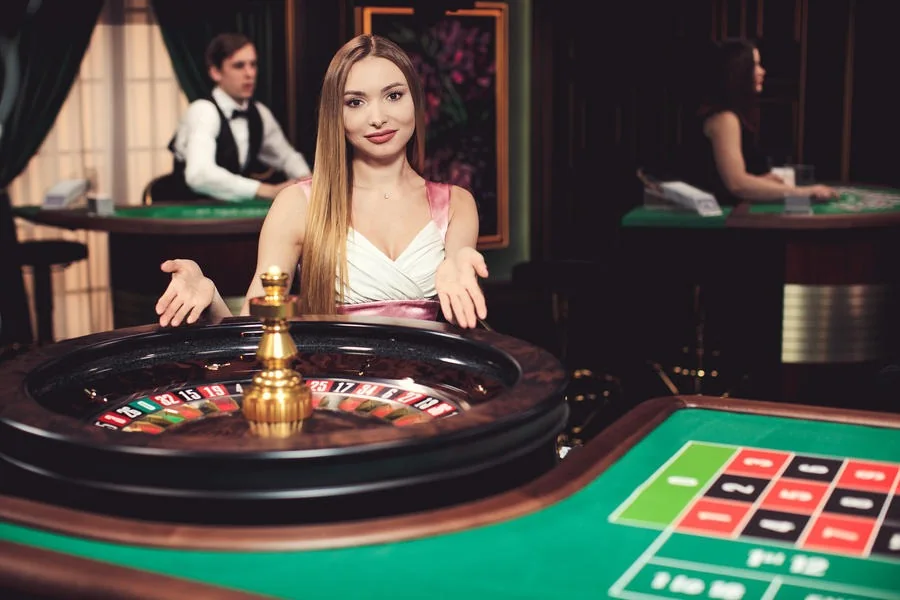 Suasana ruang kasino live dengan dealer dan meja permainan